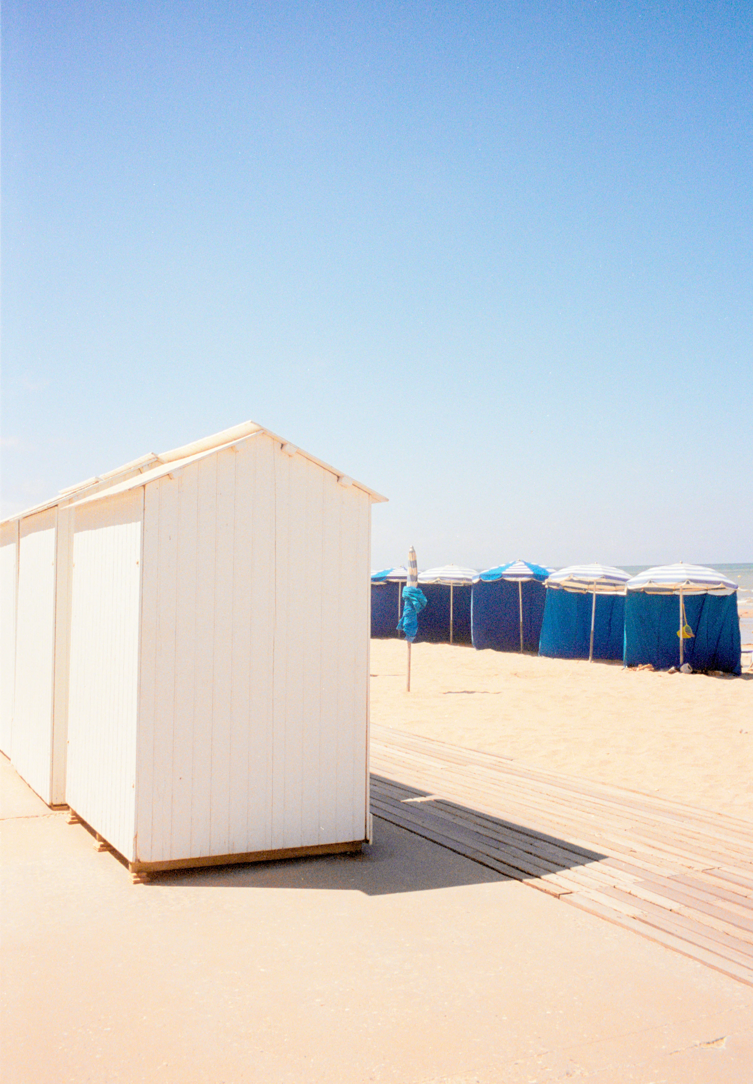 White beach huts and blue tents in Blonville