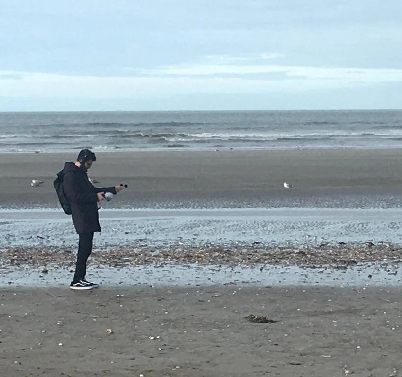 Georges Daou making a field recording on the shore in Trouville