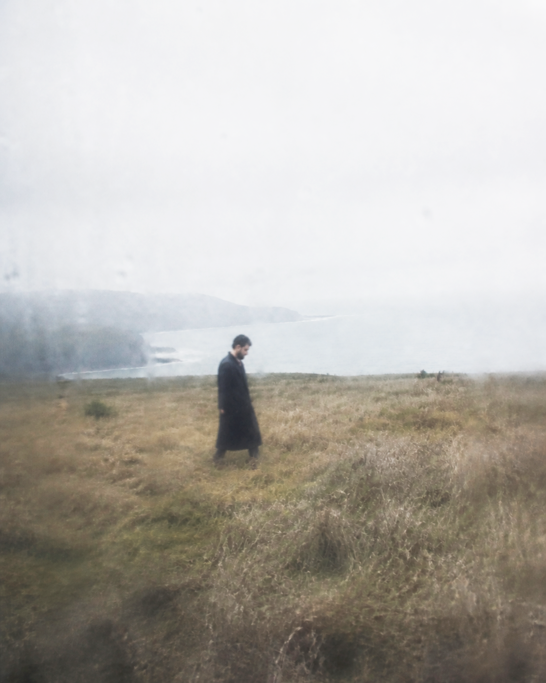 Georges Daou walking through a coastal landscape